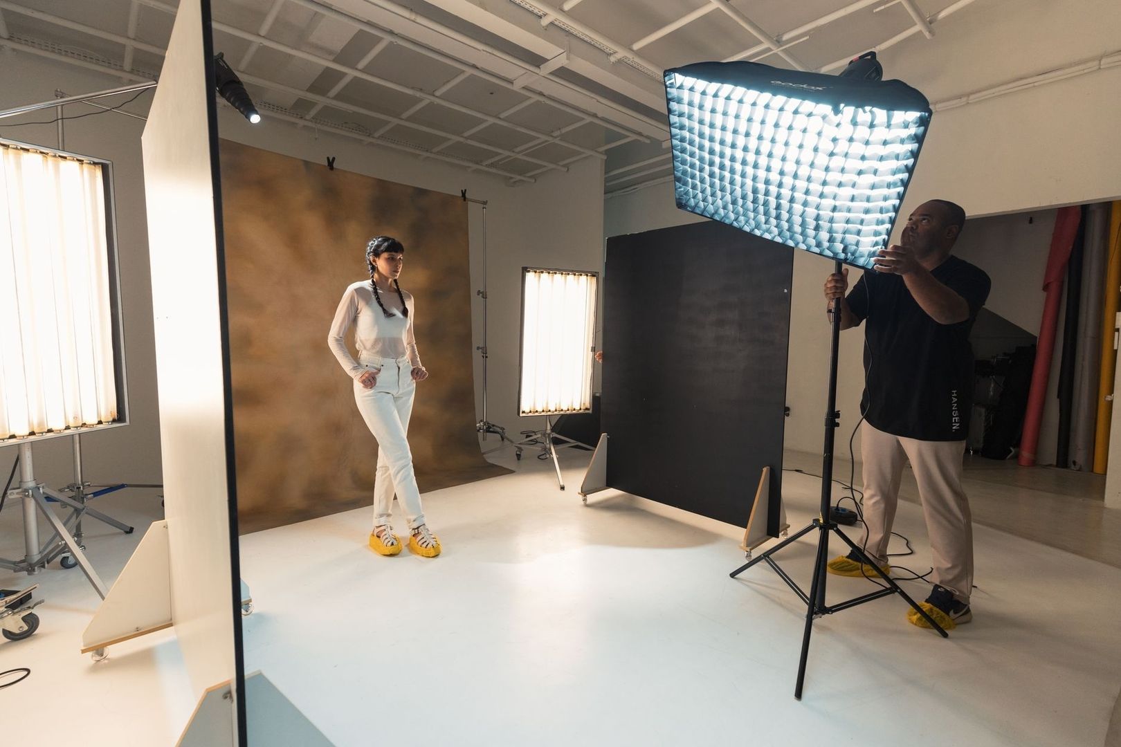 Modell och fotograf förbereder en porträttfotografering i studio